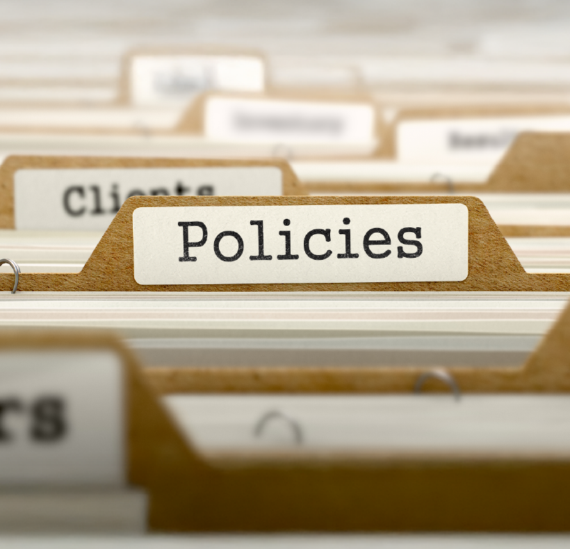 Organized filing cabinet with labeled folder tabs, highlighting "Policies" file.
