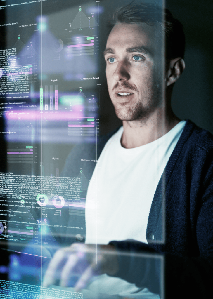A man working on a transparent screen with various graphs and text.
